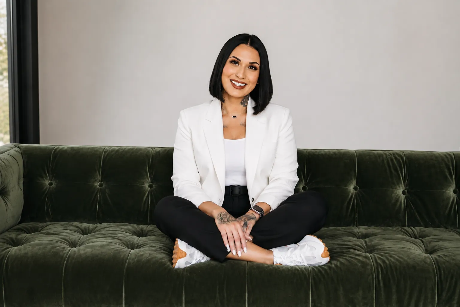 Melissa relaxing on a green couch, sharing credit education and guidance